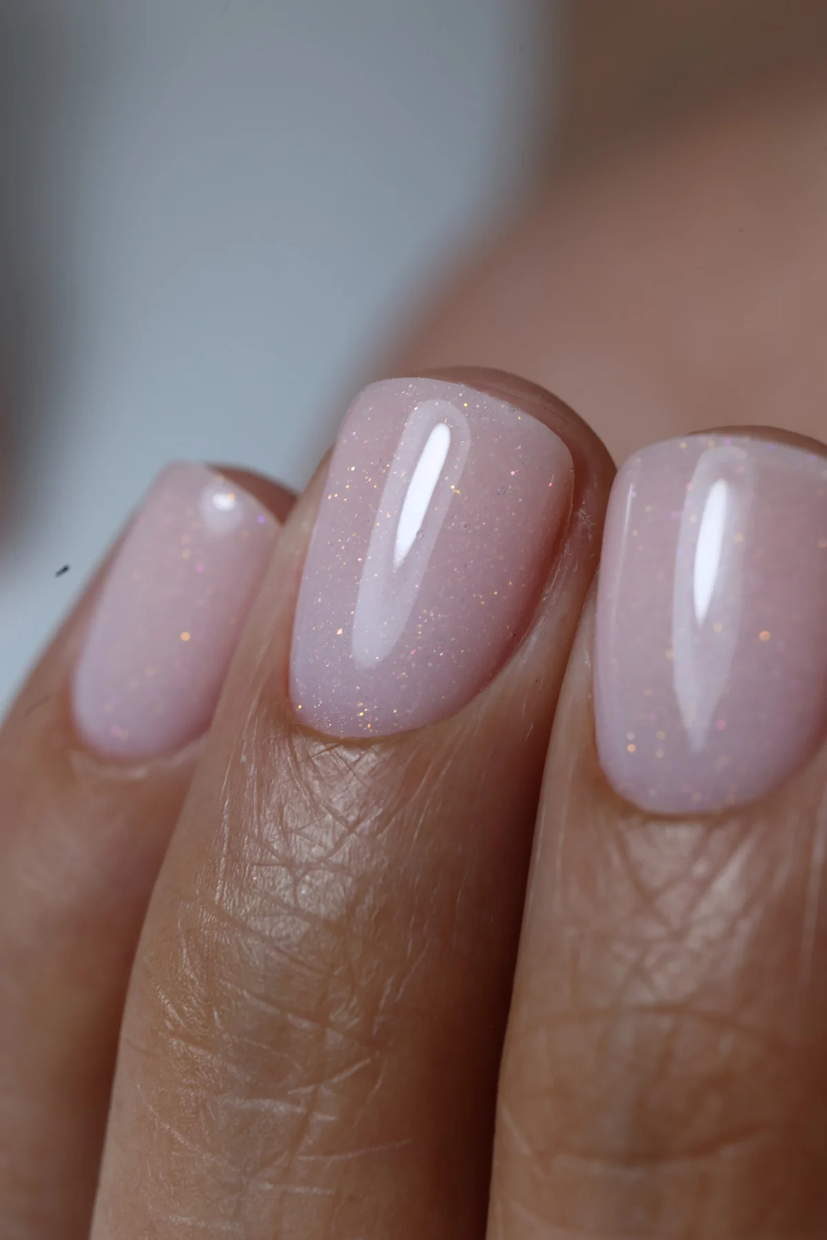 Close-up of pale pink shimmer nails by Natalia Bulat