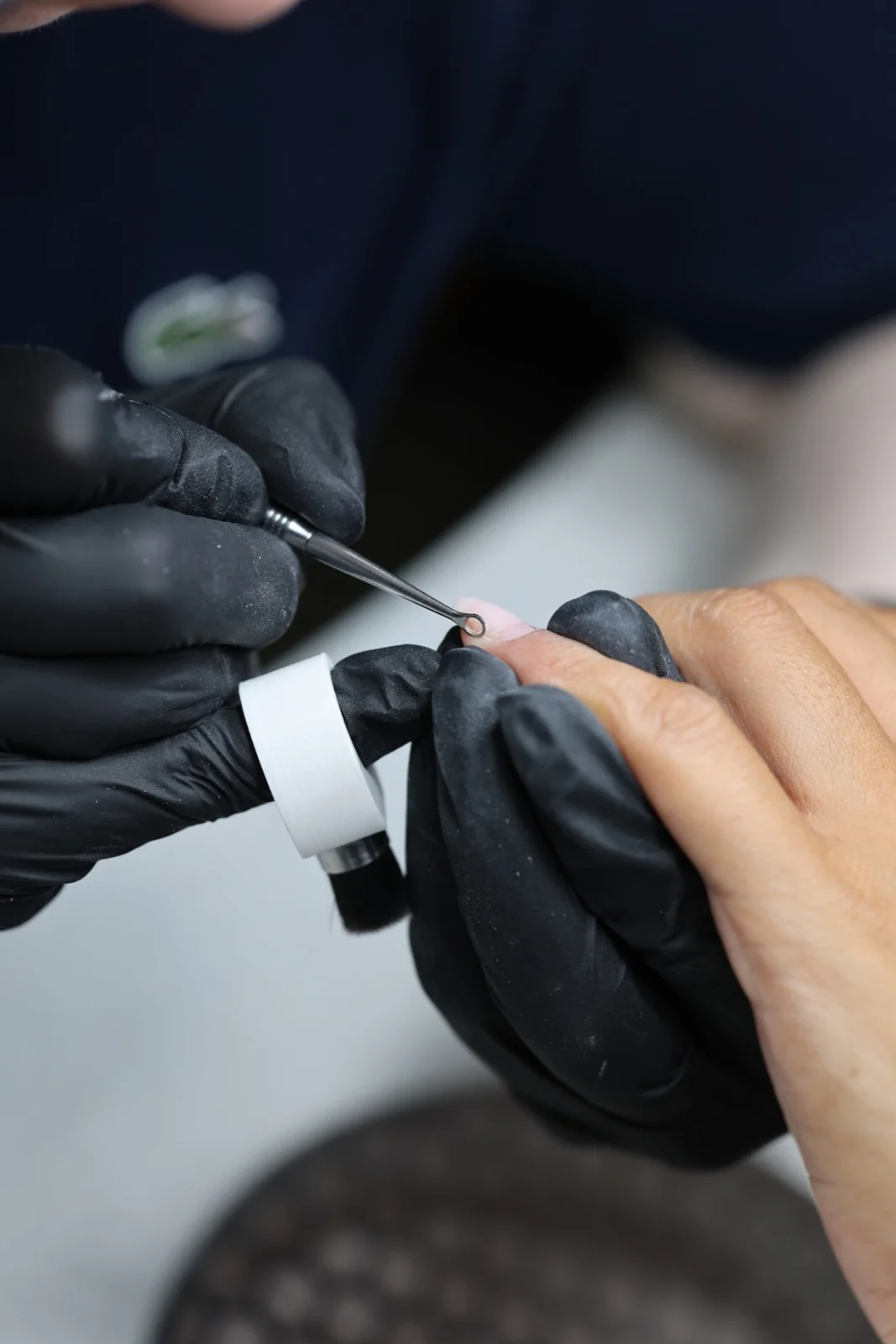 Close-up of precise cuticle preparation with a manual loop tool